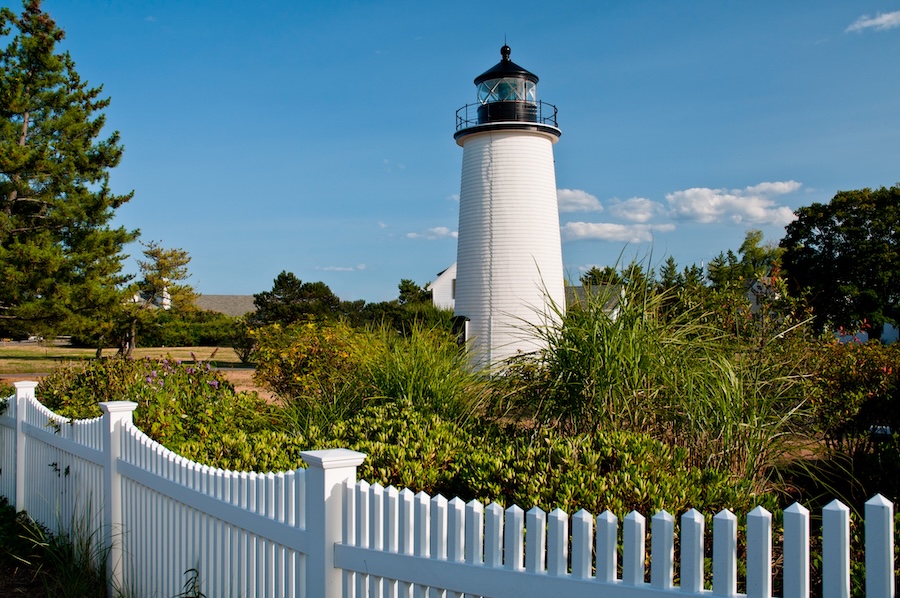 Photo of a lighthouse on a bright sunny day of the North Shore of Mass. 