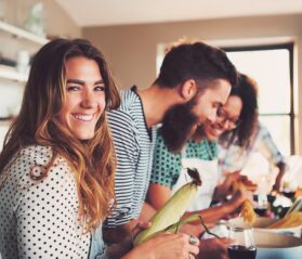 Photo of friends cooking together in a vacation rental home
