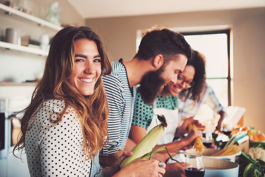 Photo of friends cooking together in a vacation rental home