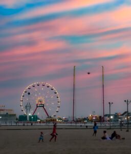 Ferris wheel at sunset with pink clouds