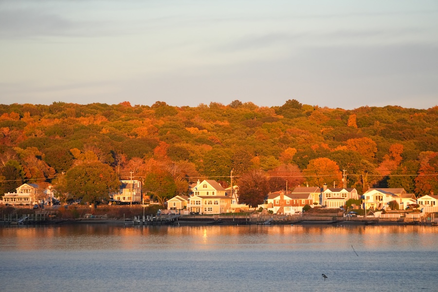 Scenic fall foliage along the Connecticut Coast with waterfront homes, a perfect New England and Mid-Atlantic fall getaway.
