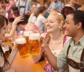 Guests celebrating at an Oktoberfest 2025 event with beer and music