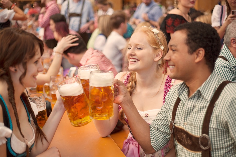 Guests celebrating at an Oktoberfest 2025 event with beer and music